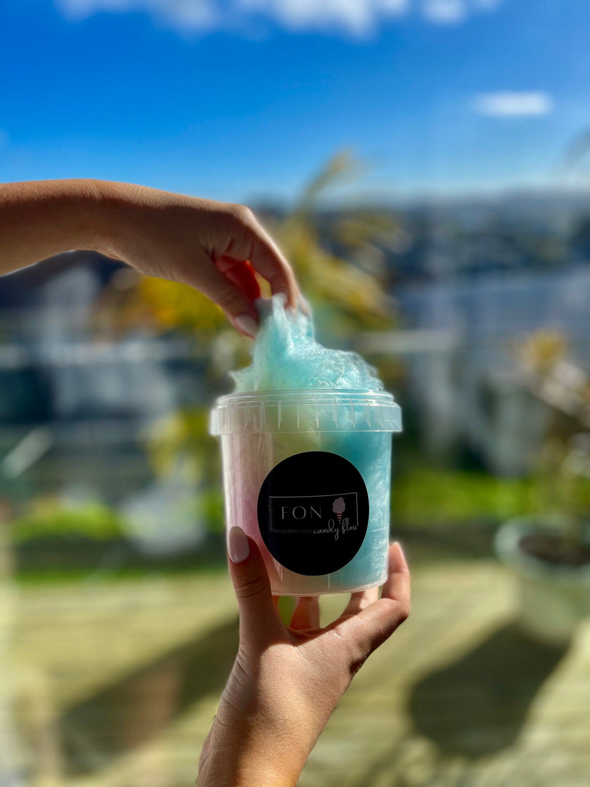 FON candyfloss tub held outdoors with fluffy candyfloss